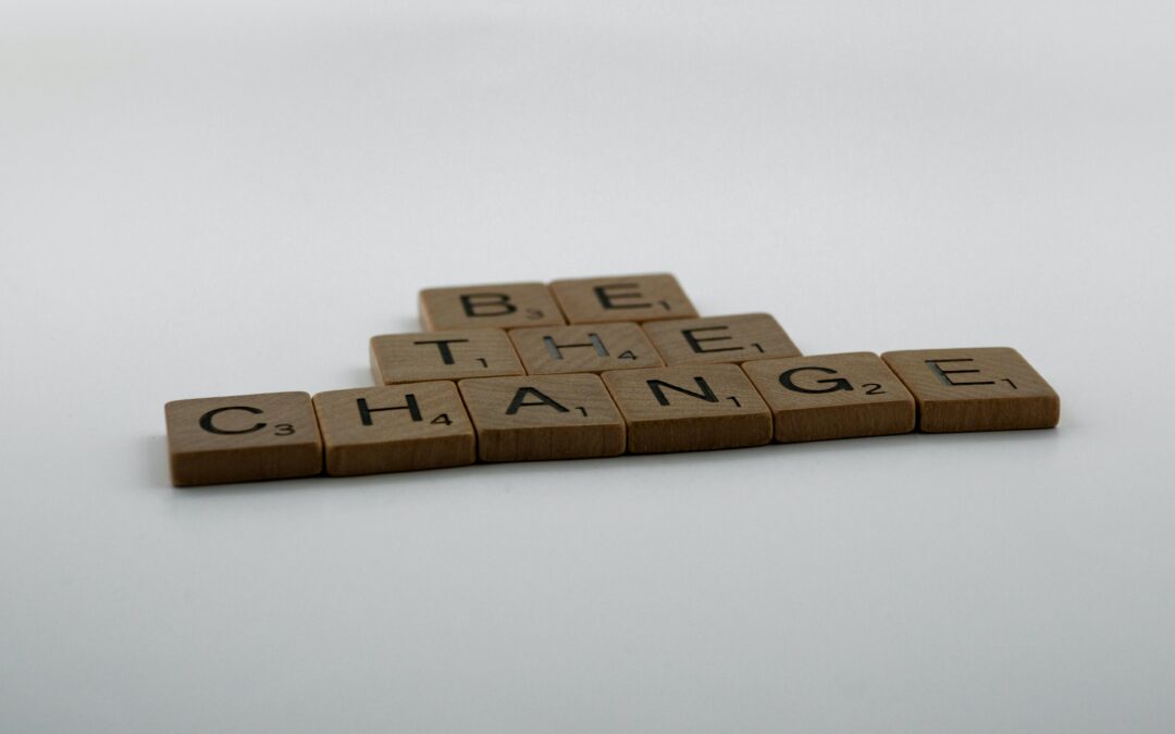 Scrabble tiles forming words: "be the change"