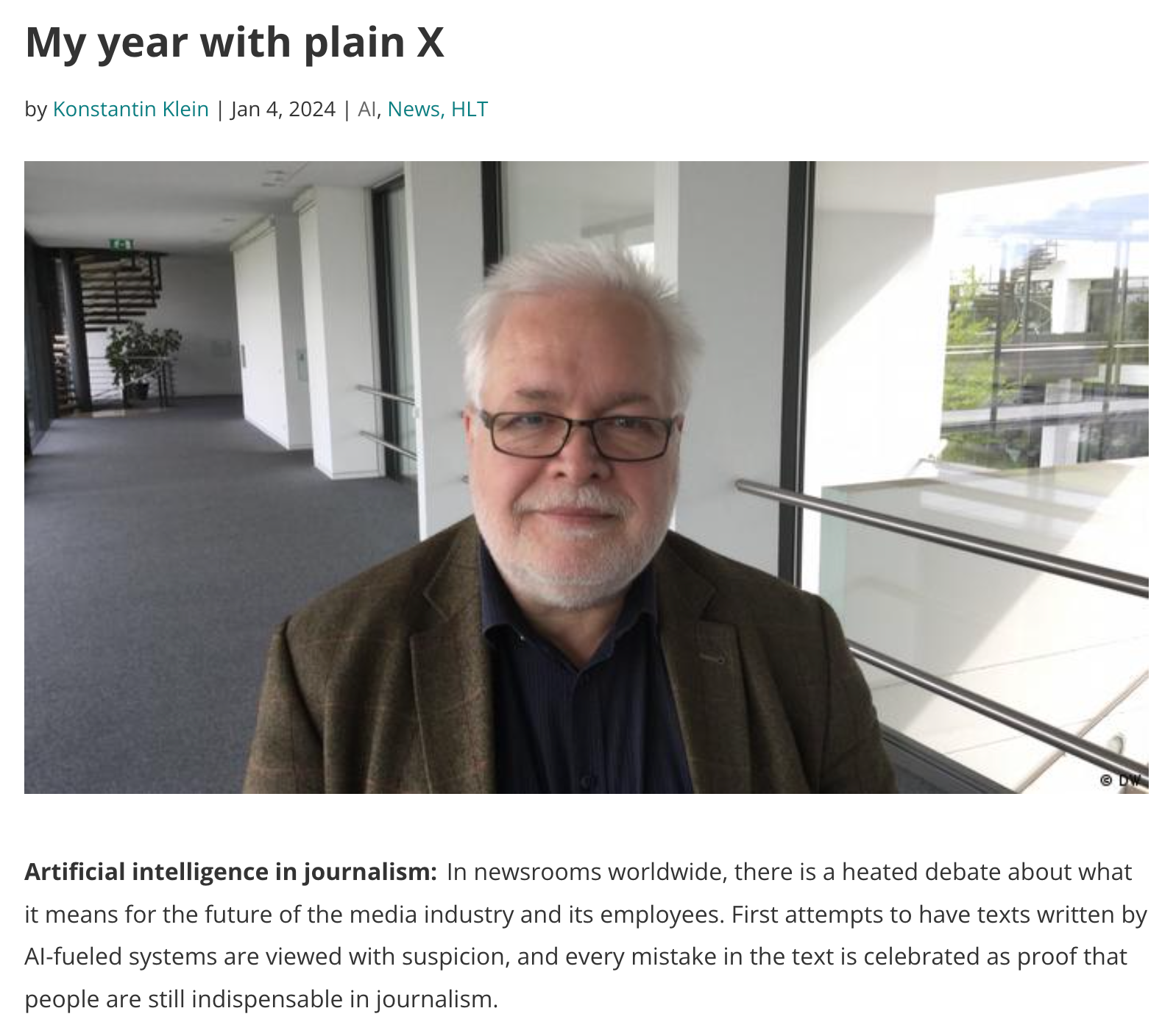 Screenshot of a blogpost called "My year with plain X" showing a photo from a man in a building looking into the camera.